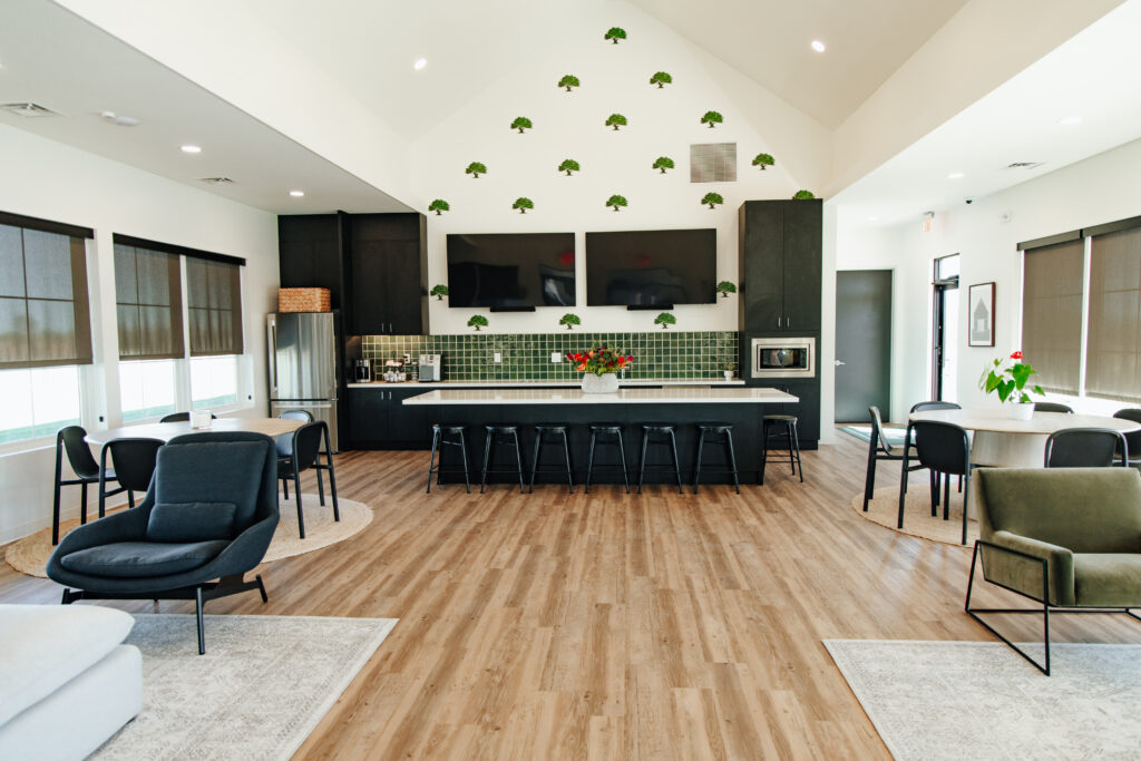 Open-concept kitchen and living area with island in Higdon Oaks model home