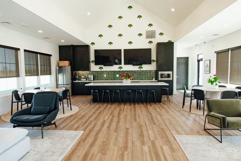 Open-concept kitchen and living area with island in Higdon Oaks model home